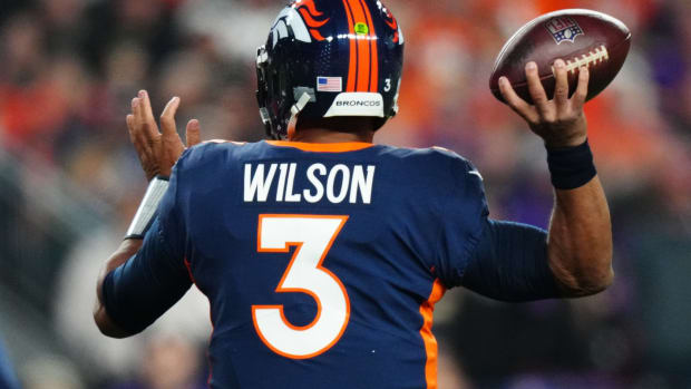 Denver Broncos quarterback Russell Wilson (3) drops back to pass against the Minnesota Vikings in the first quarter at Empower Field at Mile High.
